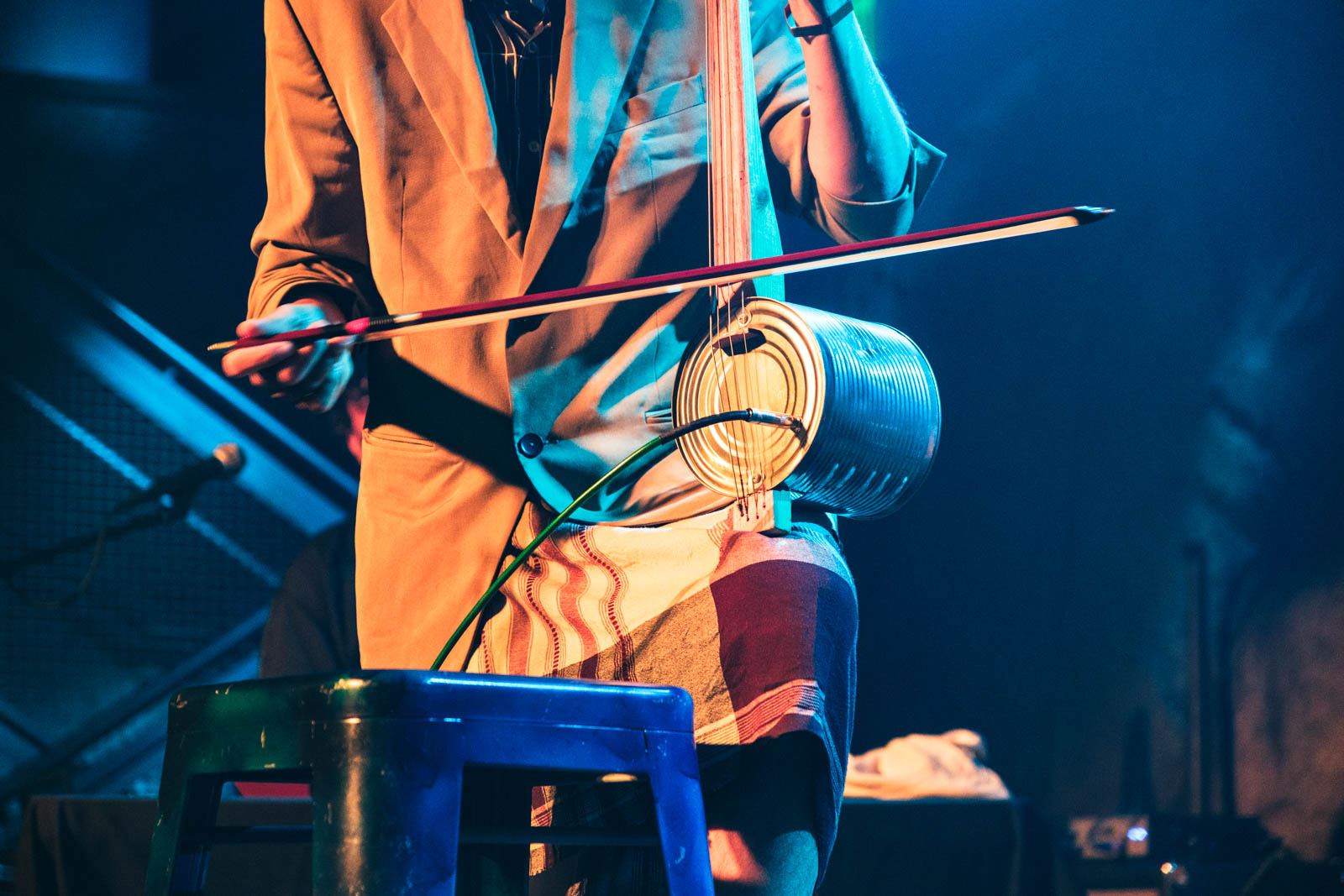 A tin-can fiddle played with a bow